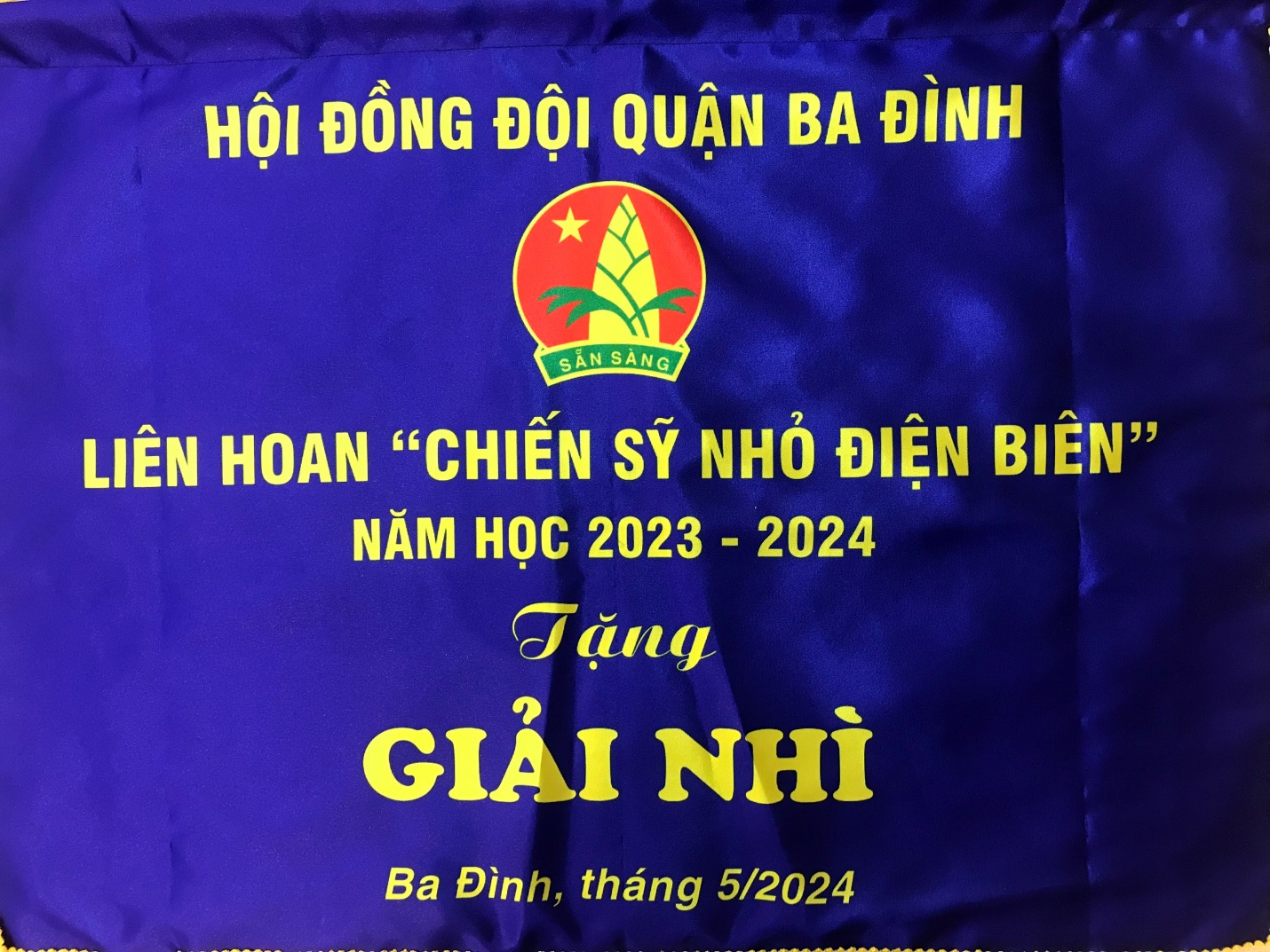 A blue fabric with yellow writing

Description automatically generated