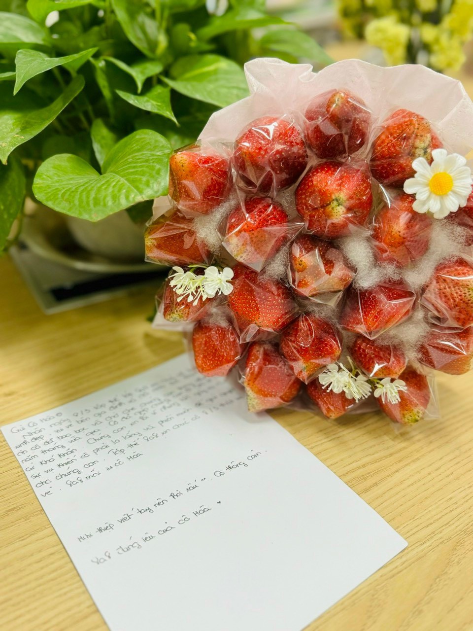 A bouquet of strawberries and a note

Description automatically generated